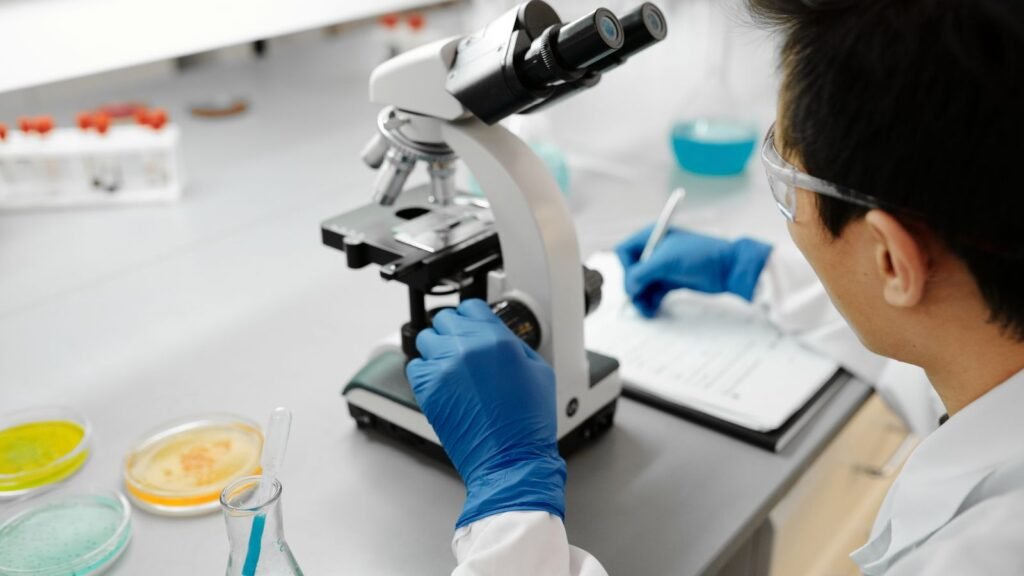Scientist analysing samples with a microscope in a laboratory