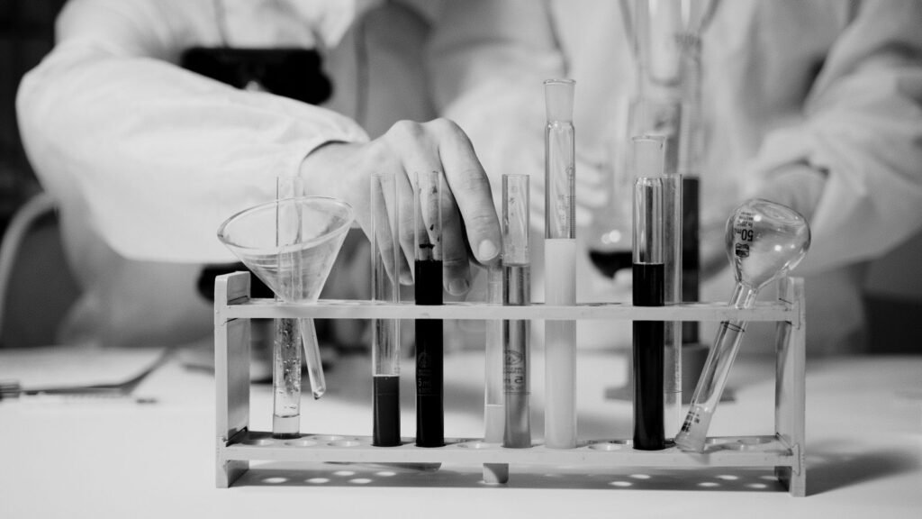 Scientist handling test tubes during a laboratory experiment