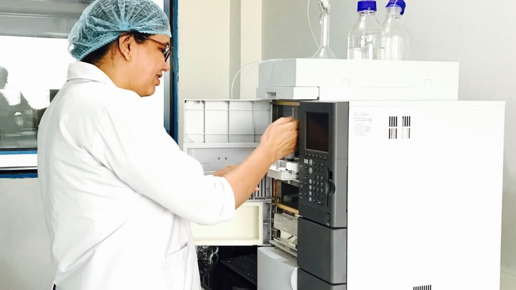 Scientist operating analytical chemistry instrumentation in a laboratory